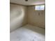 Small unfinished basement room with a window and simple decor at 8250 Ralph Ln, Denver, CO 80221