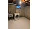 Unfinished basement laundry area with washer, sink and concrete walls at 8250 Ralph Ln, Denver, CO 80221