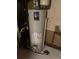 Water heater in an unfinished basement with concrete walls and floor at 8250 Ralph Ln, Denver, CO 80221