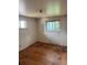 Bedroom with wood floor, natural lighting from two windows, and neutral walls at 8250 Ralph Ln, Denver, CO 80221
