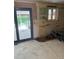 A kitchen needing remodeling with exposed walls, no cabinets, and a door that leads to backyard at 8250 Ralph Ln, Denver, CO 80221