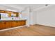 Open concept kitchen and dining area with light wood floors at 540 S Forest St # 7-102, Denver, CO 80246