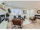 Bright and airy living room with hardwood floors and a modern fireplace at 3031 S Golden Way, Denver, CO 80227