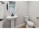 Powder room with pedestal sink and modern fixtures at 1749 Marlowe E Cir, Erie, CO 80516