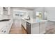 Modern kitchen with white cabinets, large island, and stainless steel appliances at 1749 Marlowe E Cir, Erie, CO 80516