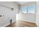 Laundry room with built-in shelving and hardwood floors at 1749 Marlowe E Cir, Erie, CO 80516