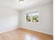Bright, empty bedroom with hardwood floors and a large window offering natural light at 1354 S Wright St, Lakewood, CO 80228