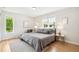 Bedroom features a queen-size bed, wood floors and natural light at 1354 S Wright St, Lakewood, CO 80228
