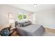 Bright bedroom features large window, hardwood floors, and modern furnishings at 1354 S Wright St, Lakewood, CO 80228