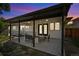 Back patio with outdoor lighting, neutral exterior, seating, patterned rug at sunset at 1354 S Wright St, Lakewood, CO 80228