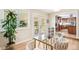 Bright dining room features a glass table and doors that lead to an outdoor space at 1354 S Wright St, Lakewood, CO 80228