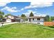 Charming one-story home with a well-maintained lawn, mature trees, and an attached garage in a suburban neighborhood at 1354 S Wright St, Lakewood, CO 80228