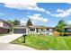 Charming one-story home with a well-maintained lawn, mature trees, and an attached garage in a suburban neighborhood at 1354 S Wright St, Lakewood, CO 80228