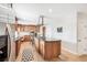 Modern kitchen features stainless steel appliances, light wood floors, dark countertops and a center island with gas cooktop at 1354 S Wright St, Lakewood, CO 80228