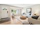 Inviting living room featuring large window, hardwood floors, neutral decor, and comfortable seating arrangement at 1354 S Wright St, Lakewood, CO 80228