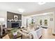 Open-concept living space featuring a seating area with fireplace, and stylish decor at 1354 S Wright St, Lakewood, CO 80228