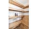Walk-in pantry with light wood shelving and wood floors at 1354 S Wright St, Lakewood, CO 80228