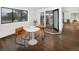 Bright breakfast nook features hardwood floors, a modern table set, and sliding doors to a patio at 2522 Zenobia St, Denver, CO 80212