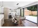 Bright dining area with modern lighting, wood table, and sliding glass doors leading to outdoor patio at 2522 Zenobia St, Denver, CO 80212