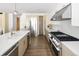 Spacious kitchen featuring stainless steel appliances, custom cabinetry, and a large island with seating at 2522 Zenobia St, Denver, CO 80212