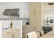 Bright kitchen featuring custom white and wood cabinetry, stainless steel appliances, and quartz countertops at 2522 Zenobia St, Denver, CO 80212