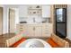 Elegant kitchenette with bright wood cabinets, a modern sink, open shelving, and a built-in wine fridge at 2522 Zenobia St, Denver, CO 80212