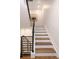 Stairway with wood stairs and black iron railing at 2522 Zenobia St, Denver, CO 80212