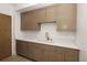 Wet bar with light-tone wooden cabinets and stone countertops at 2522 Zenobia St, Denver, CO 80212