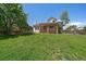 Spacious backyard with a wooden fence, mature trees, and a cozy back porch at 11506 Greenbriar Ln, Parker, CO 80138