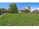 Large, well-maintained backyard with a wooden fence and a view of the home's back porch at 11506 Greenbriar Ln, Parker, CO 80138