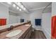 Modern bathroom featuring a double sink vanity, large mirror, and tub with white subway tile at 11506 Greenbriar Ln, Parker, CO 80138