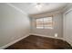 Cozy bedroom with hardwood floors, ceiling fan, and a closet at 11506 Greenbriar Ln, Parker, CO 80138