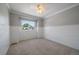 Carpeted bedroom with wainscoting, a ceiling fan, and a window providing exterior views at 11506 Greenbriar Ln, Parker, CO 80138