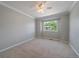 Empty bedroom with ceiling fan, neutral carpet, and window overlooking mature trees at 11506 Greenbriar Ln, Parker, CO 80138