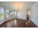 Light-filled dining room featuring hardwood floors, elegant chandelier, and large windows at 11506 Greenbriar Ln, Parker, CO 80138