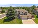 Charming two-story home with a manicured lawn, mature trees, and a spacious three car garage at 11506 Greenbriar Ln, Parker, CO 80138