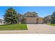 Charming two-story home featuring a well-manicured lawn and an attached three-car garage at 11506 Greenbriar Ln, Parker, CO 80138