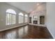 Inviting living room with hardwood floors, arched windows and a brick fireplace at 11506 Greenbriar Ln, Parker, CO 80138