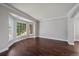 Bright living room with hardwood floors, crown molding, and a large bay window at 11506 Greenbriar Ln, Parker, CO 80138