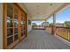 Large covered patio with natural light and wooden railing overlooking surrounding neighborhood at 11506 Greenbriar Ln, Parker, CO 80138