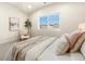 Bright bedroom with large window, neutral decor, and comfortable bedding at 875 E 78Th Ave # 69, Denver, CO 80229