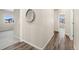 Clean and bright hallway with wood-look flooring and access to bedrooms at 875 E 78Th Ave # 69, Denver, CO 80229