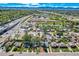 A scenic aerial view shows a residential area near a highway, with mountain views in the distance at 4835 Harlan St, Wheat Ridge, CO 80033