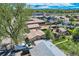An aerial view displaying the property's surroundings, including storage sheds, fenced-in yards, and detached garages at 4835 Harlan St, Wheat Ridge, CO 80033