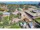 An aerial shot of the property showcasing its location within a neighborhood with detached garages and fenced yards at 4835 Harlan St, Wheat Ridge, CO 80033