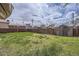 Large backyard featuring a shed and tall privacy fence at 4835 Harlan St, Wheat Ridge, CO 80033
