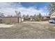Spacious backyard with multiple storage structures and partial gravel at 4835 Harlan St, Wheat Ridge, CO 80033