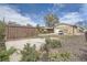 Open backyard with detached garage and additional storage structures at 4835 Harlan St, Wheat Ridge, CO 80033