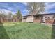 Backyard featuring a covered patio and partial fence at 4835 Harlan St, Wheat Ridge, CO 80033