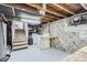Unfinished basement with exposed ceiling beams and laundry area at 4835 Harlan St, Wheat Ridge, CO 80033